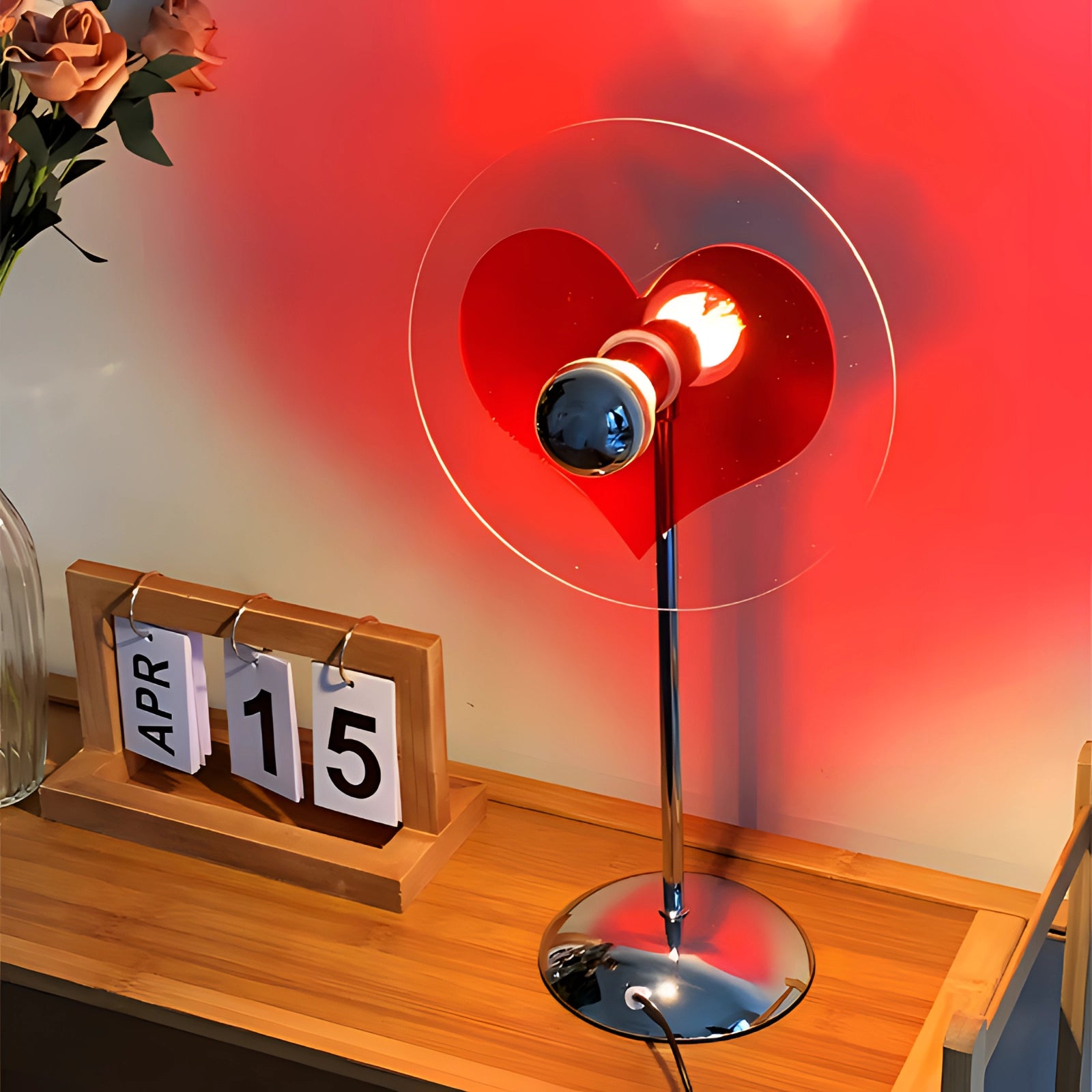 LED heart projector lamp with a romantic red and magenta glow designed for home decor, suitable as a Valentine's gift, with a sleek and modern design, casting light in a circular pattern.