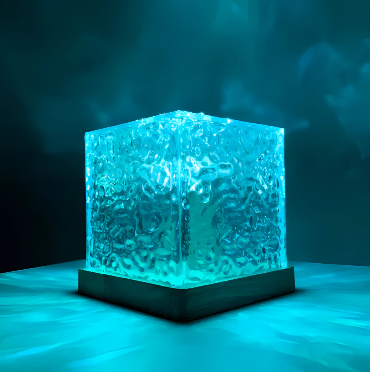 Blue glowing LED ice cube light sculpture with a rectangular shape and liquid-like appearance, featuring a variety of 16 color options including electric blue and aqua, resembling a glass art piece.