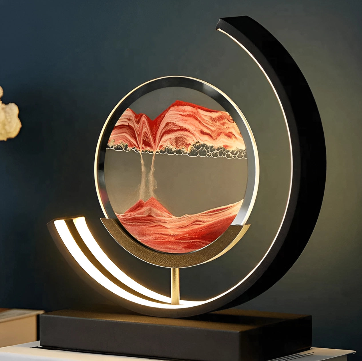 Crescent moon-shaped LED kinetic sand lamp with mood lighting, featuring warm orange and red hues.