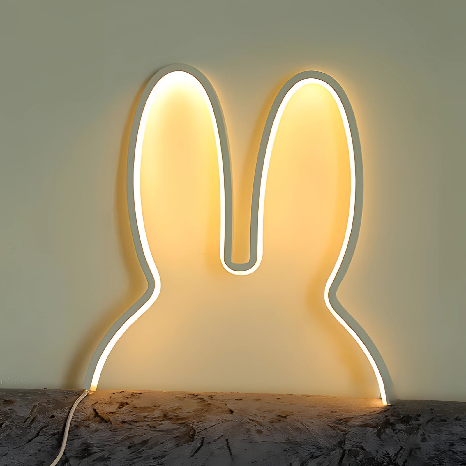 A modern decorative silhouette lamp in the shape of a rabbit, featuring LED lighting, with a sleek white finish, set against a dark background.