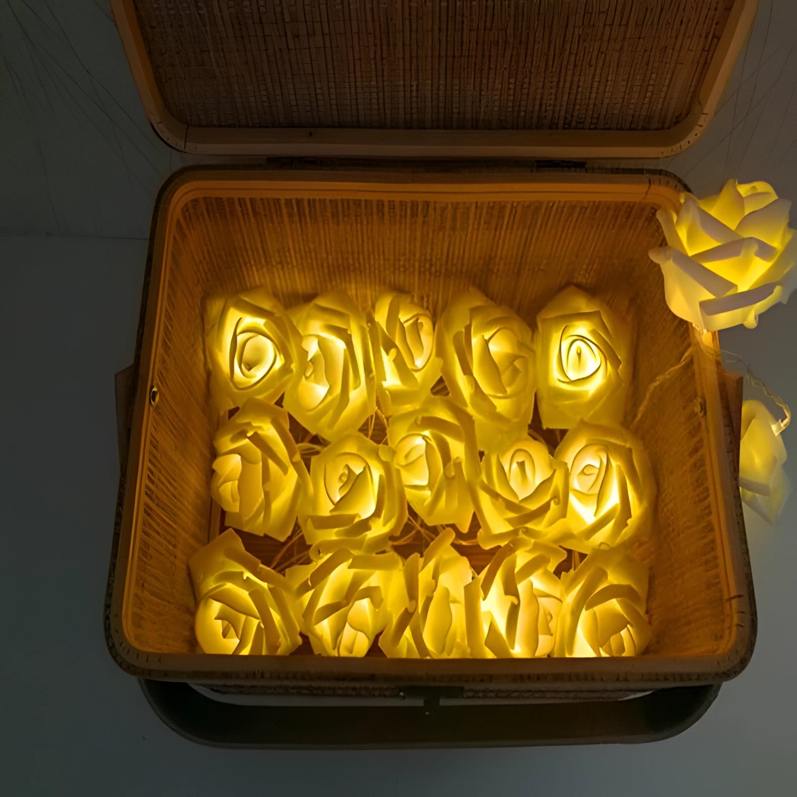 Battery-operated LED rose string lights with gold and amber glow, ideal for romantic decor.