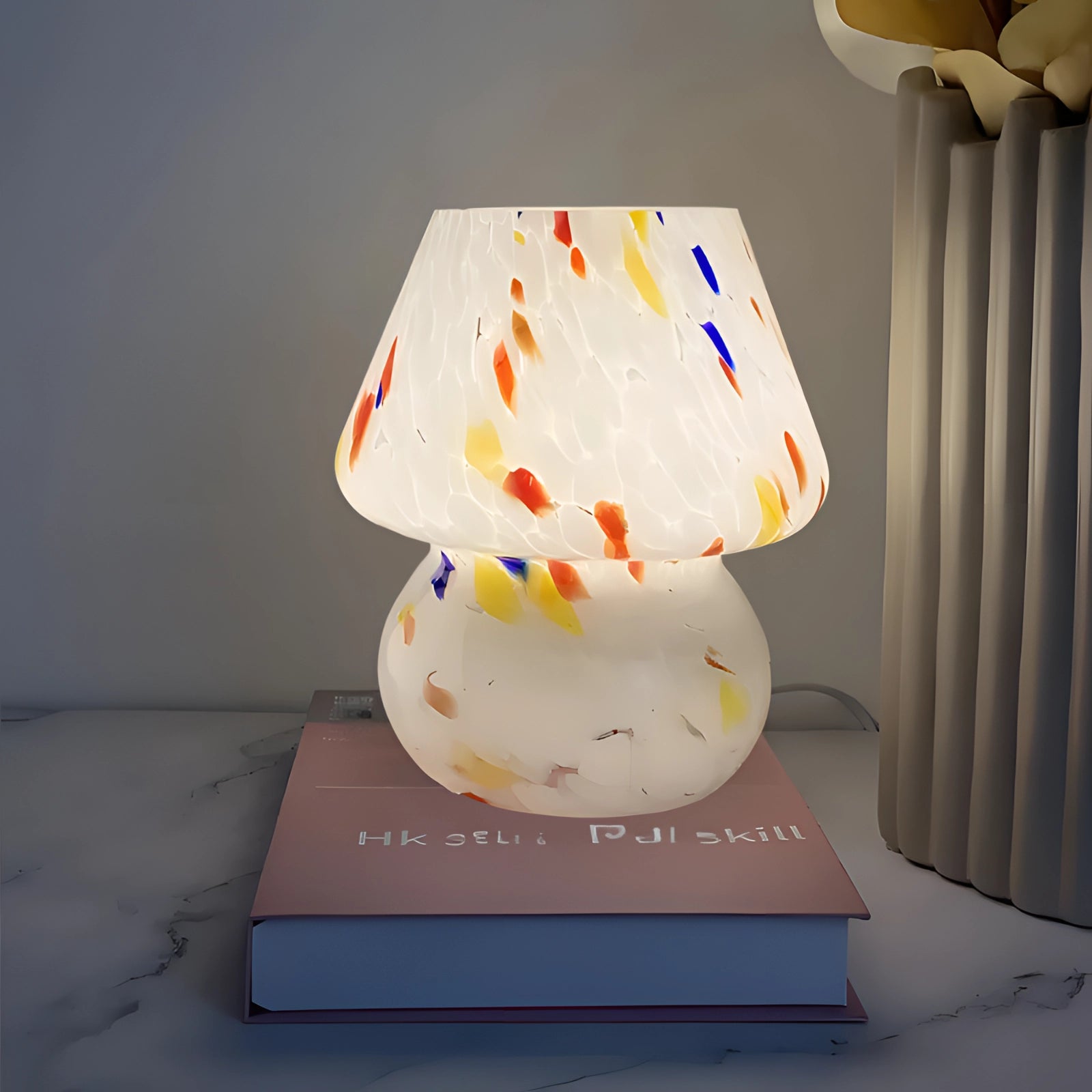 Luxurious blue swirl glass marble lamp placed on a table, complementing modern elegant decor with its artistic design.