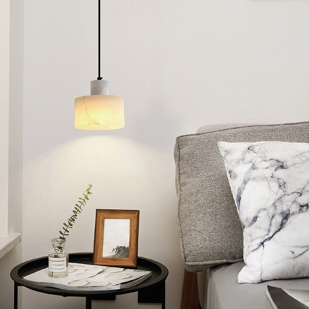 Luxury Alabaster Pendant Light hanging from the ceiling, featuring minimalist natural stone design, illuminating an elegant, modern interior with wooden accents.