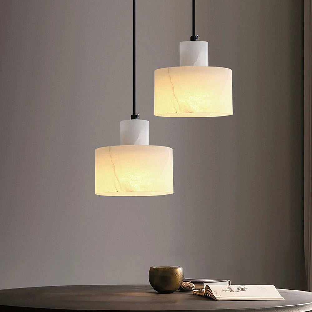 Luxury Alabaster Pendant Light made of natural stone, minimalist ceiling lamp with a rectangular design, hanging in an interior space with wooden accents.