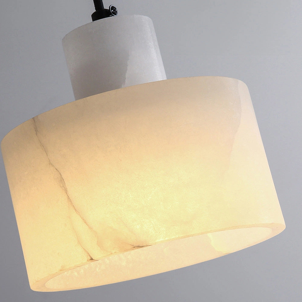 Luxury Alabaster Pendant Light in natural stone with a minimalist rectangular design, beige color, and wooden accents, hanging from the ceiling.
