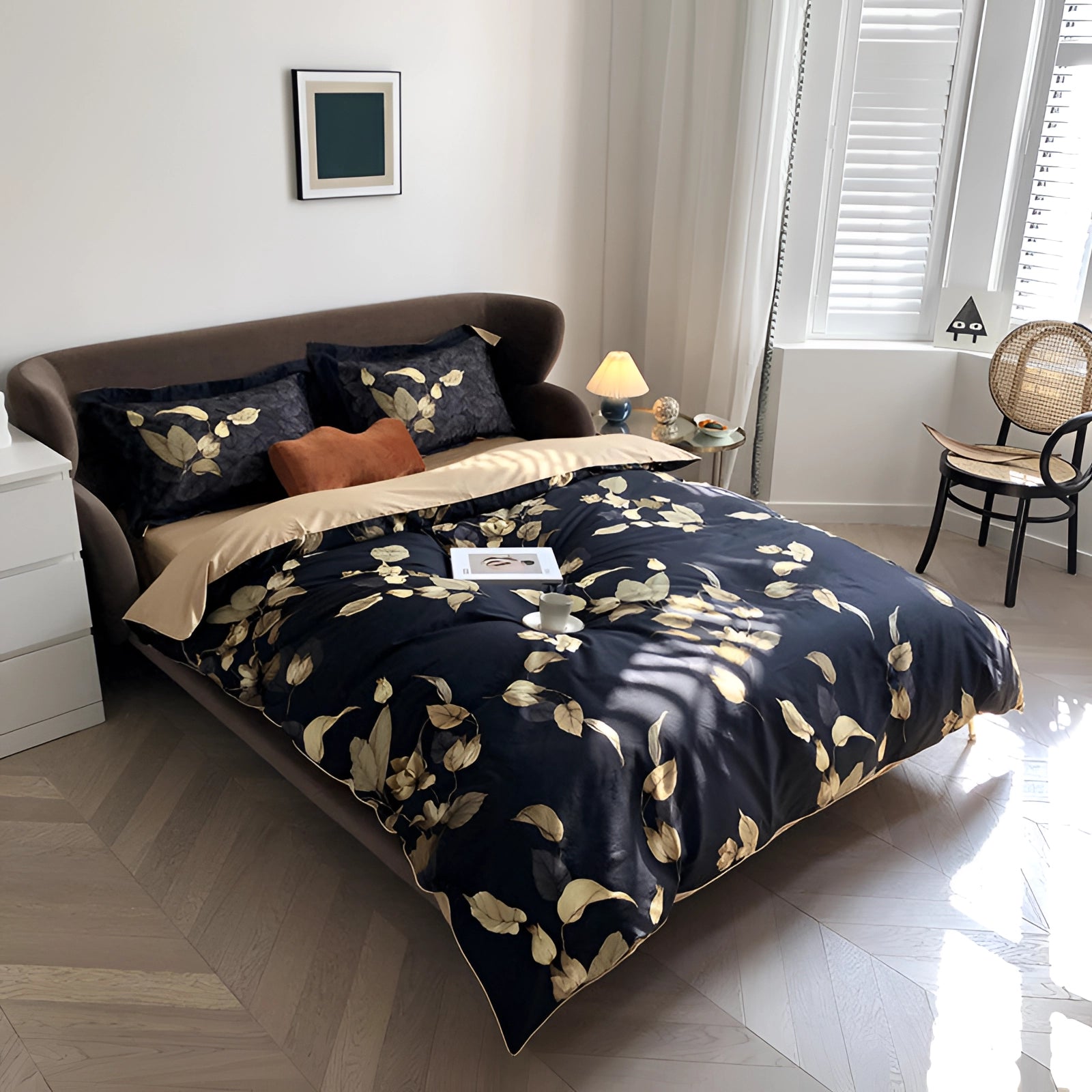 Luxury black and gold floral duvet cover on a neatly made bed with a wooden bed frame, placed on a hardwood floor.