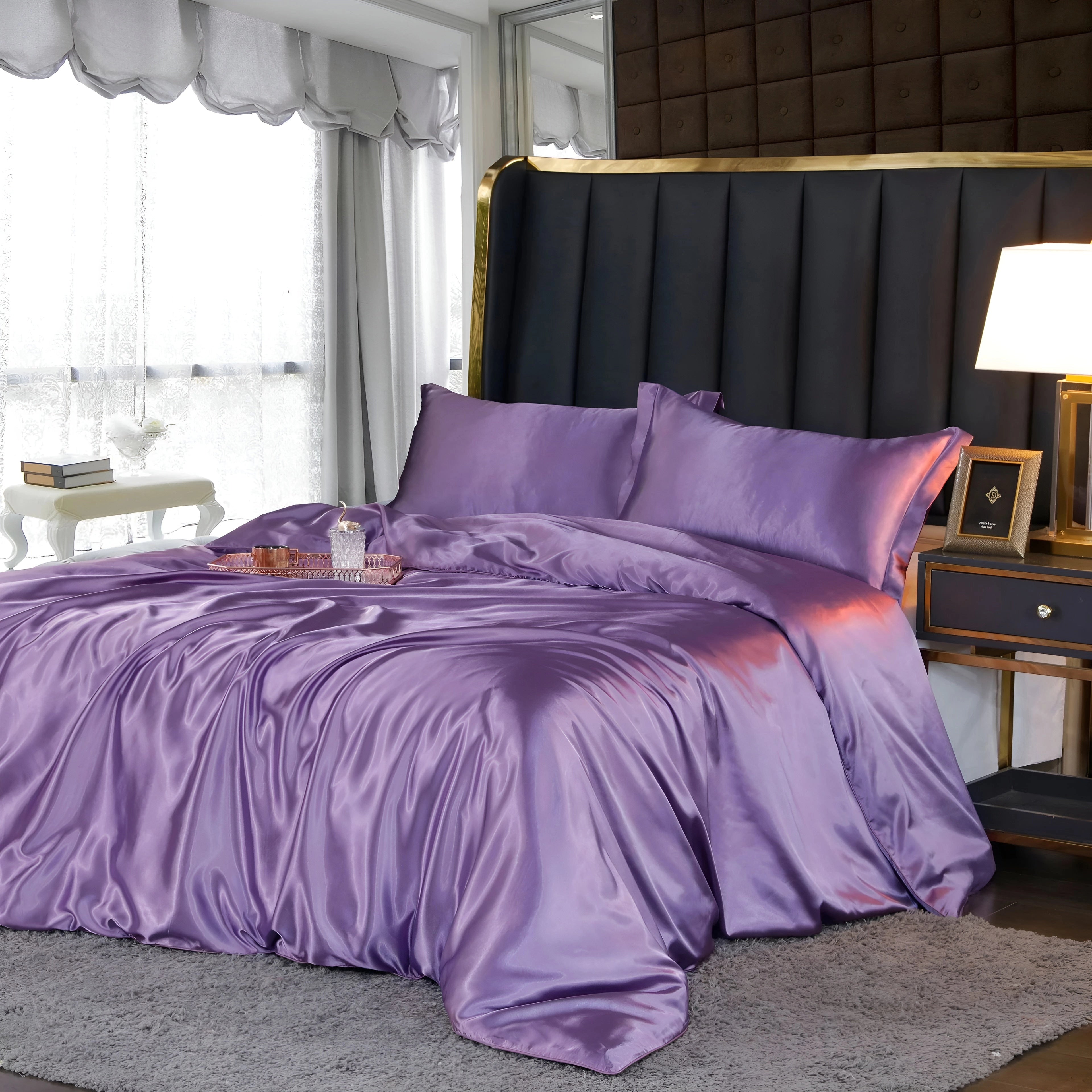 Luxury black leather bed with gold and marble accents in a spacious room, featuring amethyst-colored bedding in the size of 220x240 cm with two matching pillowcases. The bed is complemented by wooden elements and is set against a backdrop of soft lighting, with curtains partially covering a window, creating a comfortable and elegant atmosphere.