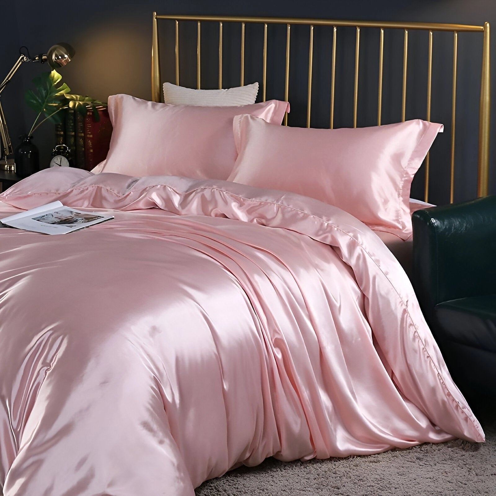 Luxury black leather bed with gold and marble accents in a peach color variant, measuring 220x240 cm. The image also includes two matching pillowcases, showcasing a sophisticated high-end furniture design. The bed is part of an elegantly styled interior, featuring hardwood flooring and a well-coordinated textile theme.