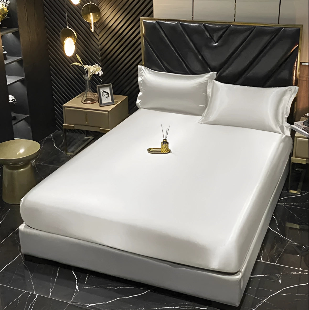 Luxury black leather bed featuring gold and marble accents, set in an elegant interior design space with polished flooring.