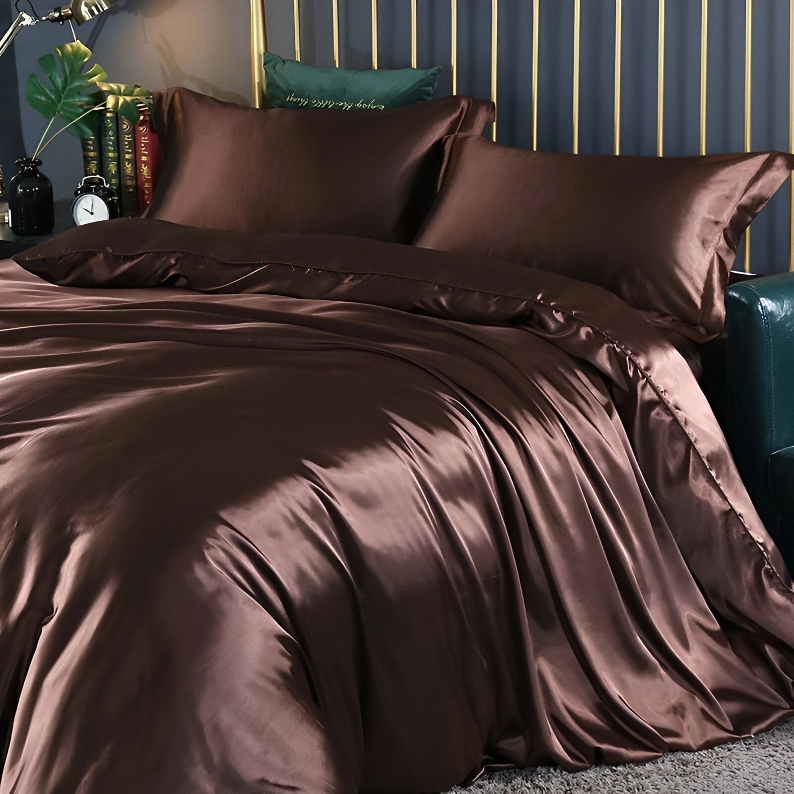 Luxury black leather bed with gold and marble accents, featuring a substantial bed frame and a sleek, modern design. The bed is set in a stylish interior with hardwood flooring.