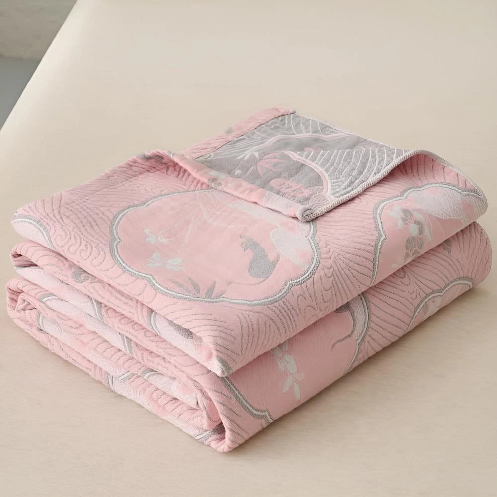 Luxury blue bedding set with ornate gold floral pattern displayed in a pink variant, featuring a 200x230cm size. The bedding exhibits intricate designs, contributing to its elegant and comfortable appearance.