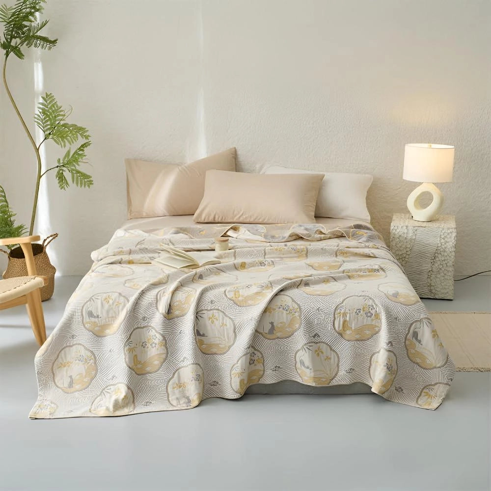 Luxury blue bedding set with ornate gold floral pattern on a bed frame, complemented by pillows; the room features wood accents and a window, creating a comfortable and elegantly designed interior space.