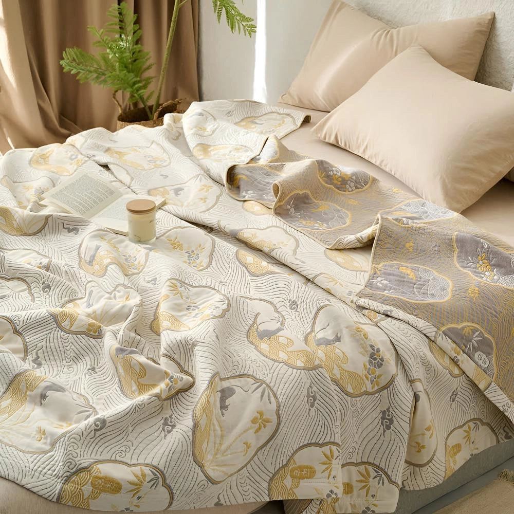 Luxury blue bedding set with ornate gold floral pattern displayed on a neatly made bed, surrounded by a serene setting featuring neutral colors and wooden accents, enhancing the comfortable and elegant ambiance.
