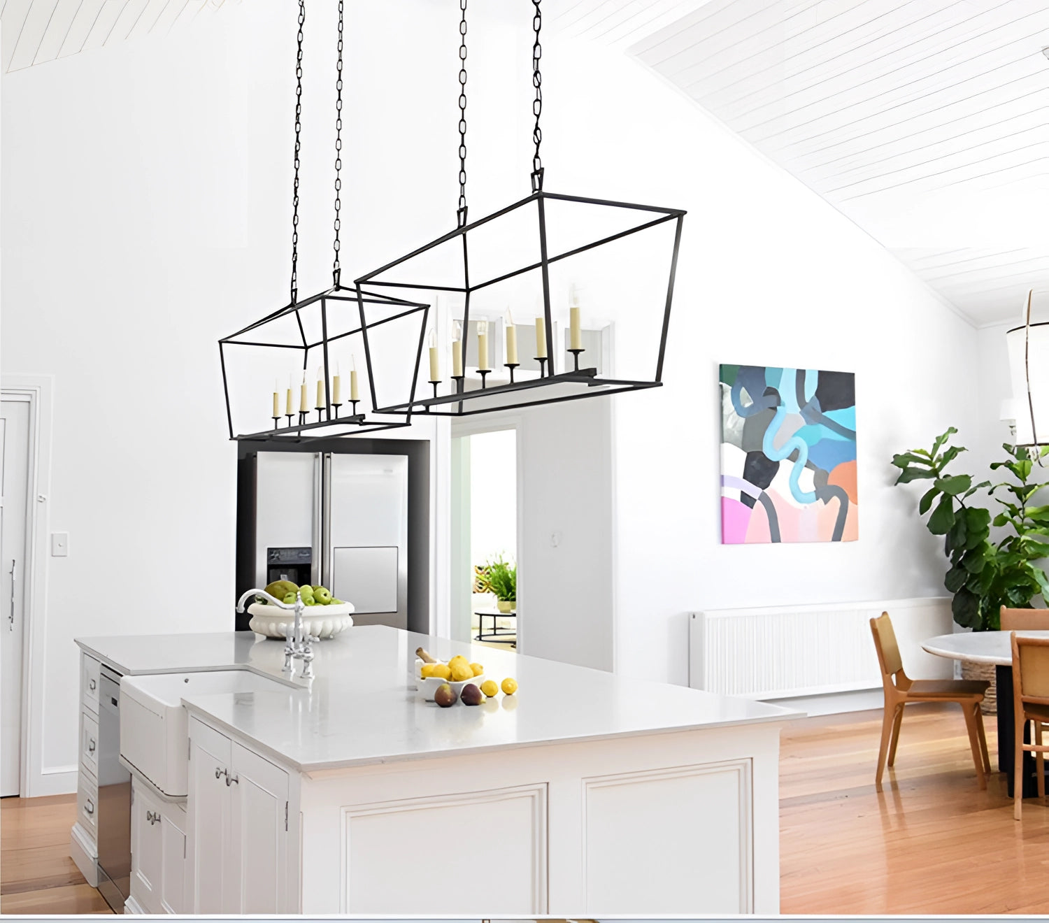 Luxury Brass LED Geometric Pendant Chandelier in Black with 6-Light feature, hanging elegantly in a modern setting with surrounding furniture and decor elements such as a table, chair, cabinetry, and houseplants.