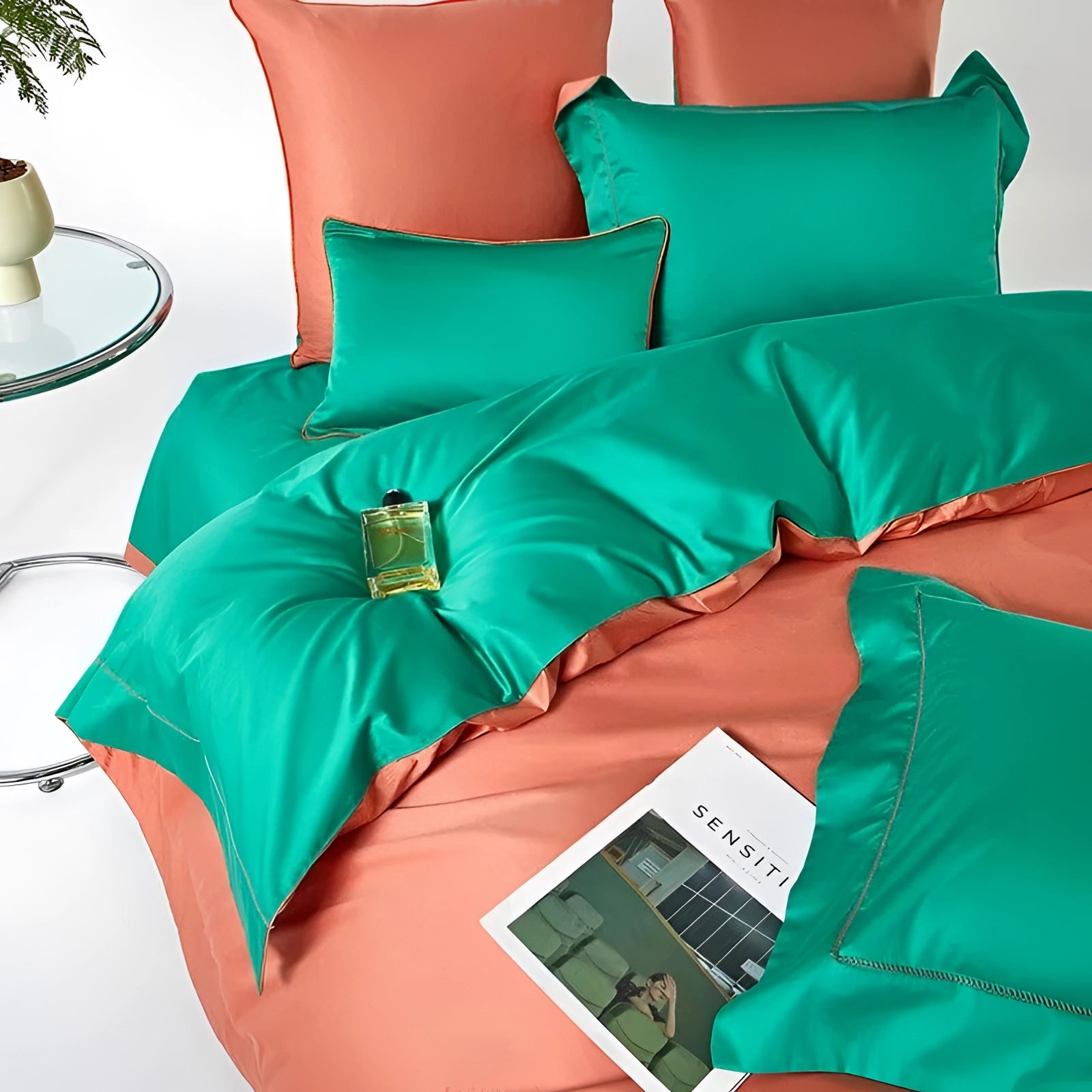 Luxurious satin bedding set in coral and teal colors, featuring a queen-sized duvet cover and matching pillows, highlighting a blend of elegance and comfort with a subtle azure and aqua touch.