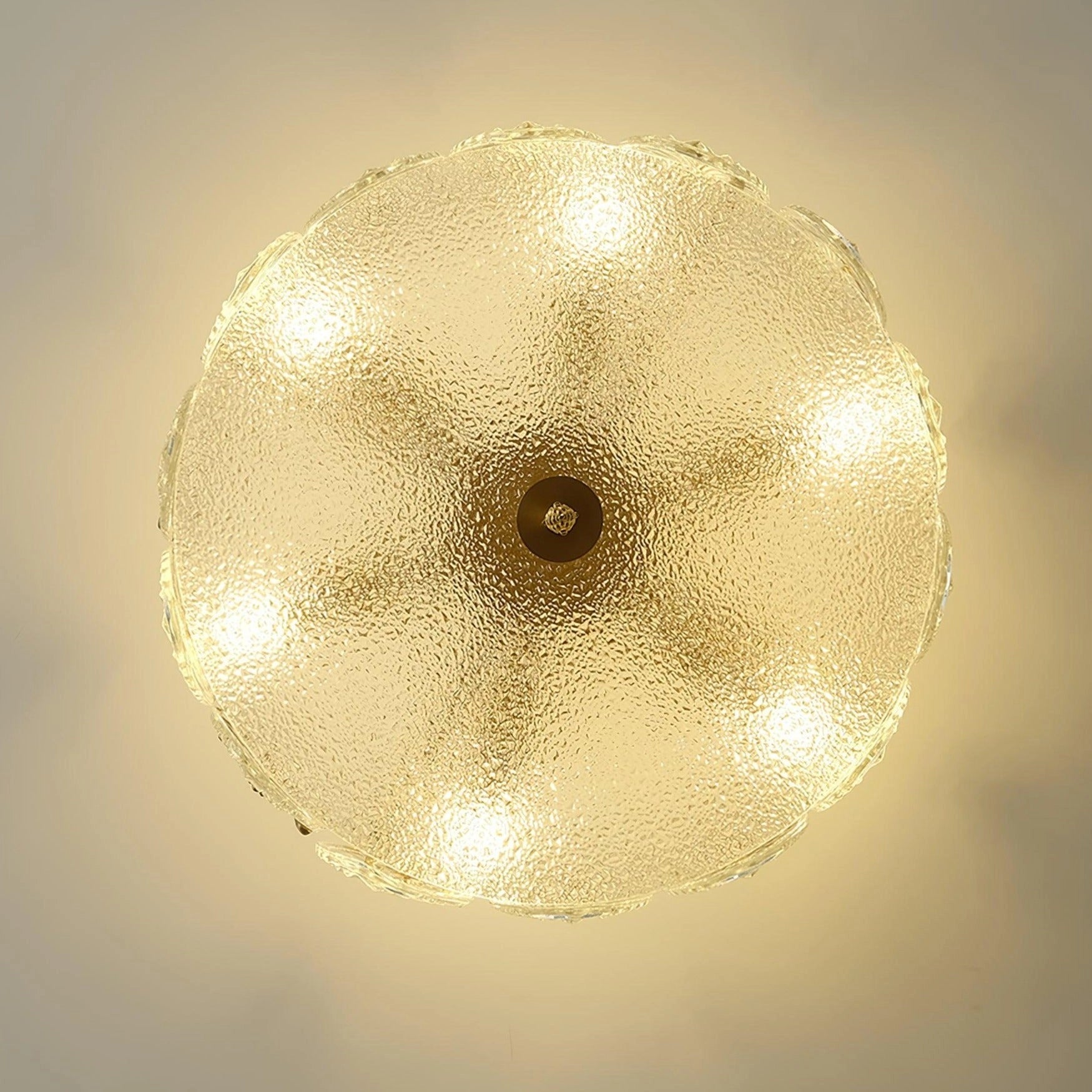 Elegant vintage gold leaf crystal chandelier with symmetrical design, hanging from a ceiling.