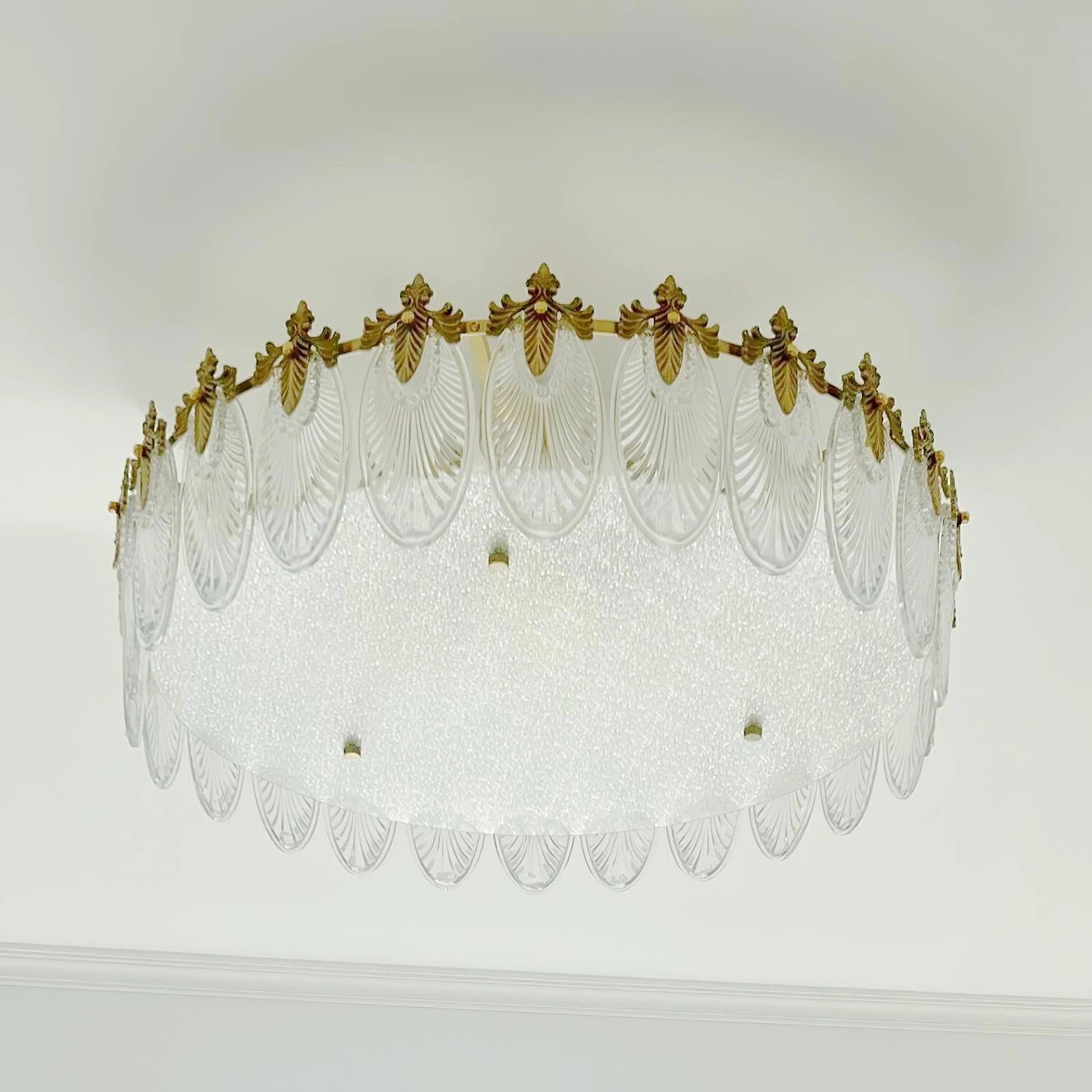 A luxurious crystal chandelier with a vintage gold leaf design, elegantly hanging from the ceiling.