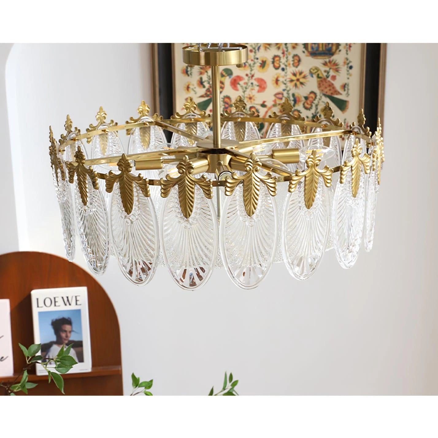 Luxury Crystal Chandelier in gold leaf with vintage design featuring intricate ornamental details and crystal embellishments, suspended from a ceiling.