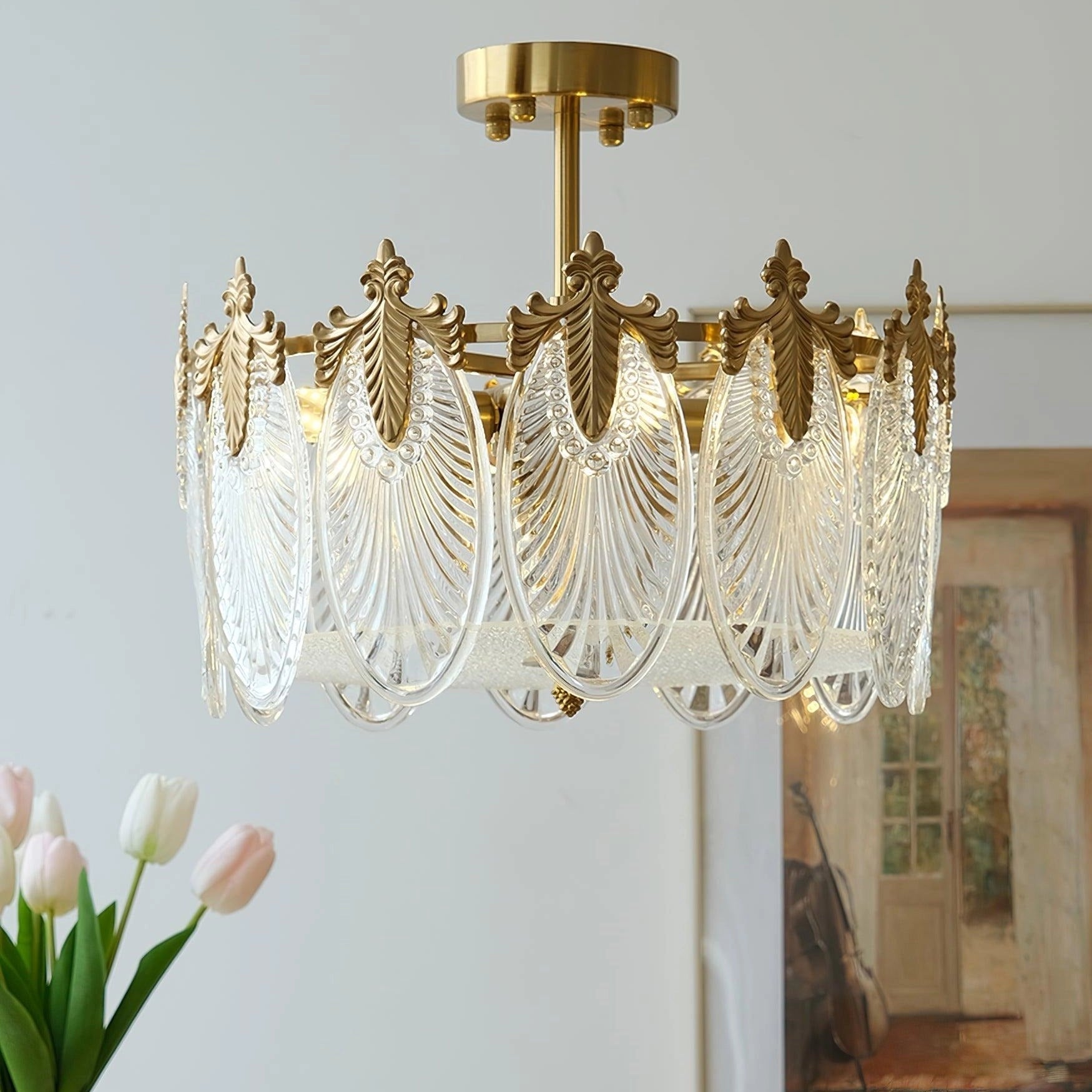 Luxury crystal chandelier with gold leaf detailing, vintage ceiling light fixture, illuminating an elegantly decorated interior featuring curtains, plants, and flowers.