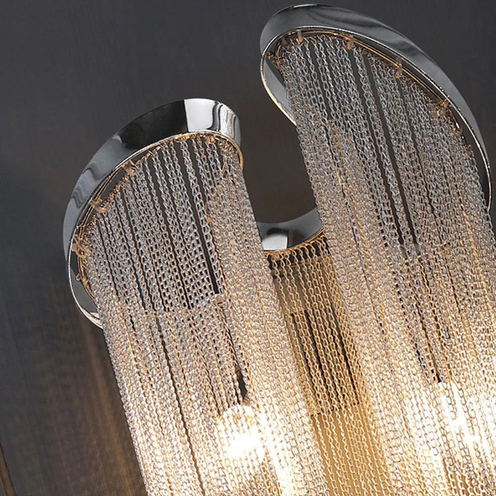 Elegant luxury crystal wall sconce with a contemporary chain drape design, featuring a polished glass and metal base. The fixture emits a sophisticated glow, ideal for modern interiors.