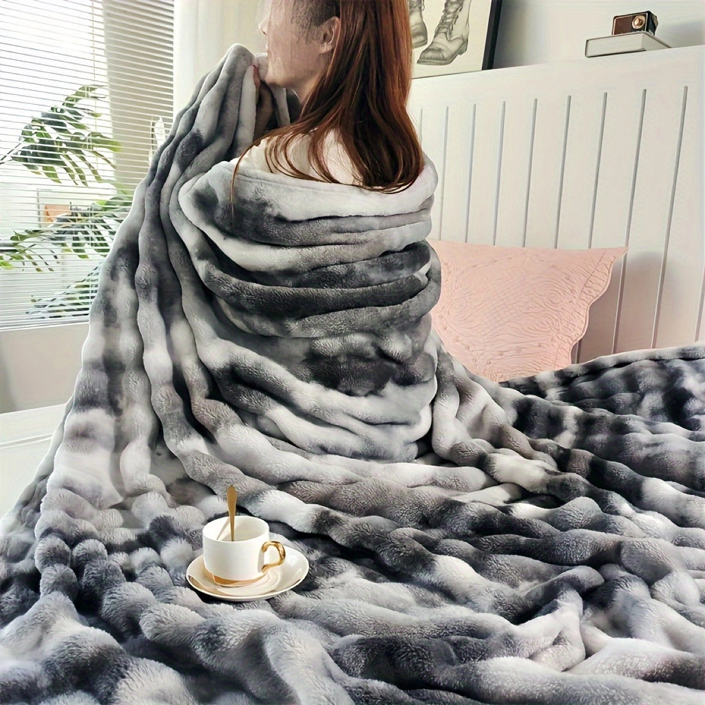 Dark gray luxury faux fur blanket draped over a wooden floor, highlighting its plush texture and cozy appeal, measuring 200 x 230 cm.