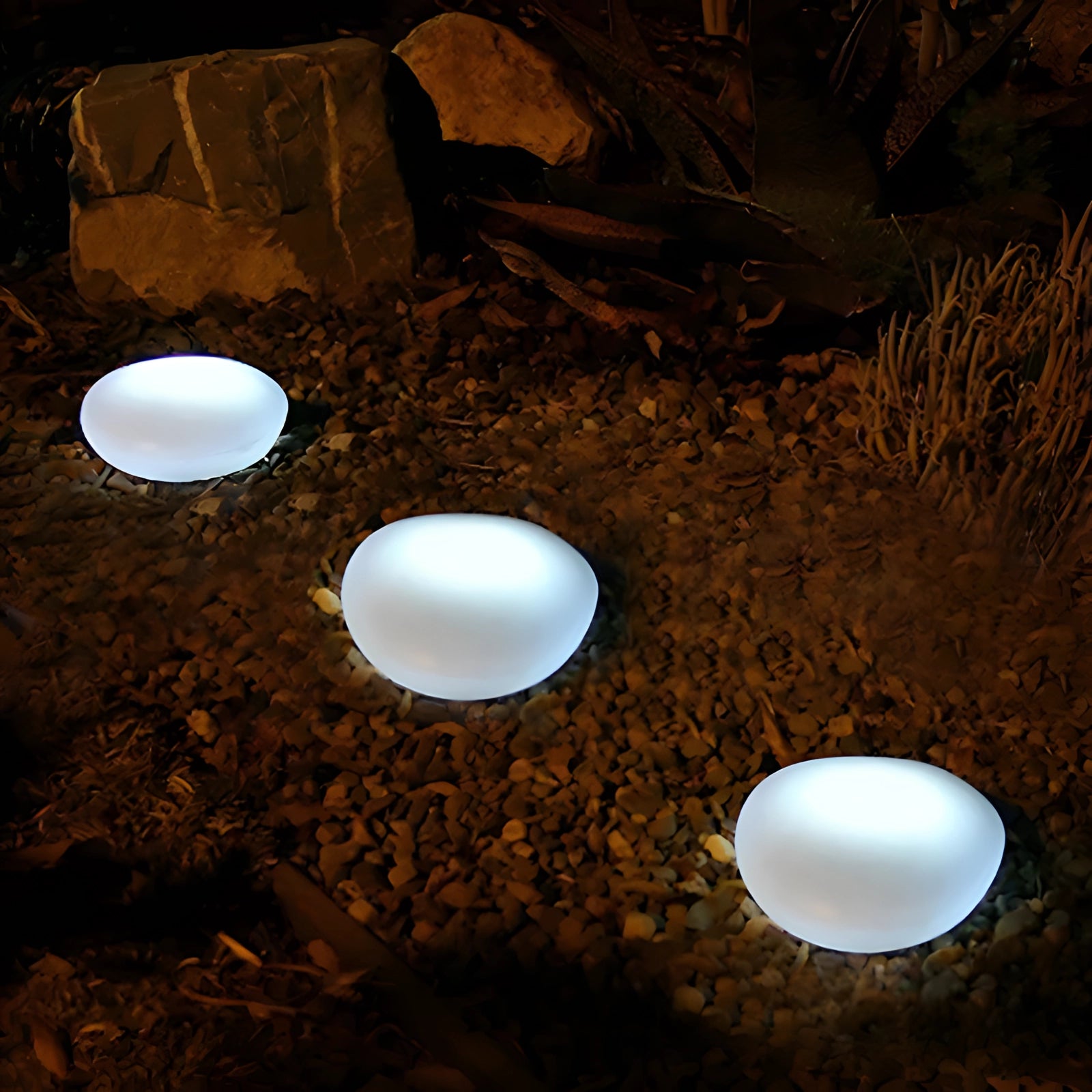 Luxurious floating pool lights in a modern outdoor setting with a sleek design, surrounded by a natural environment featuring grass, rocks, and wood elements.