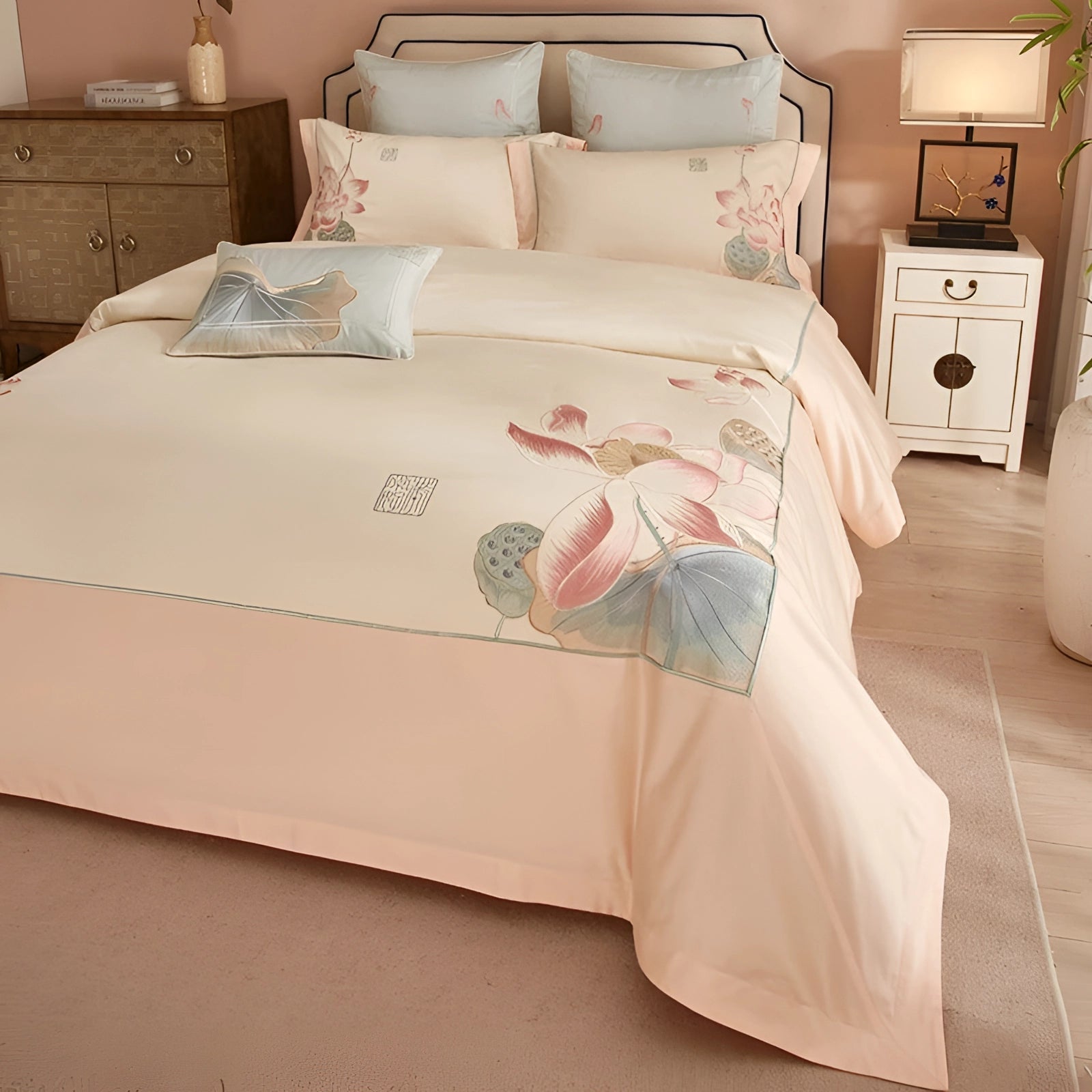 Luxury floral bedding set in a peach botanical design, featuring a duvet cover and matching pillow set, displayed on a white bed with a wooden frame in a stylishly designed bedroom interior.