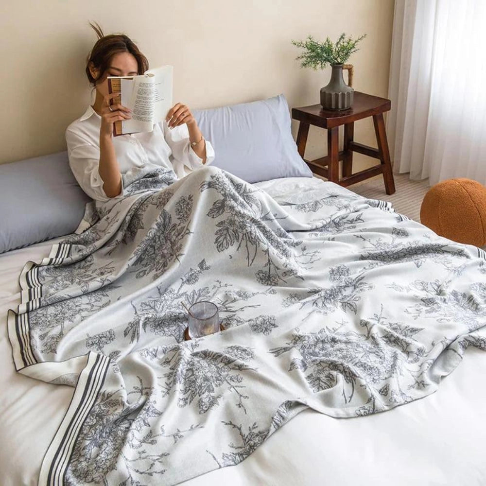Luxurious floral cotton duvet cover with botanical patterns, elegantly draped over a bed in a beautifully designed bedroom featuring wooden furniture and a cozy atmosphere.