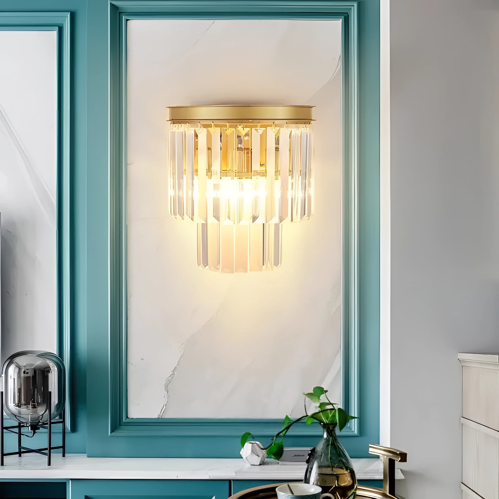 Luxury glass wall sconce with gold accents, featuring a contemporary design, mounted on a wooden wall in a modern living room setting.