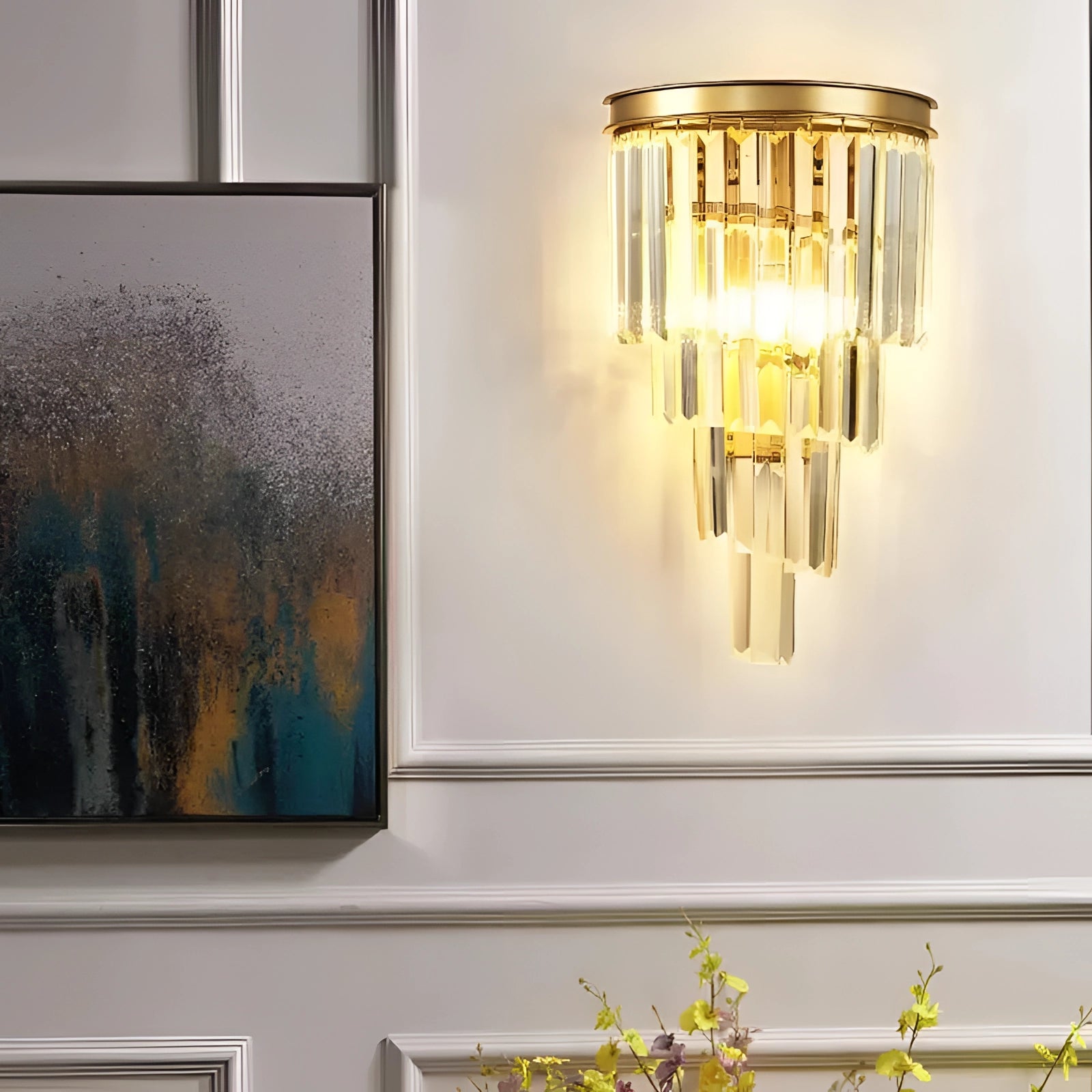 Luxury glass wall sconce with gold accents mounted on a wall, featuring a contemporary design suitable for a living room, with a rectangular shape and a warm yellow glow.