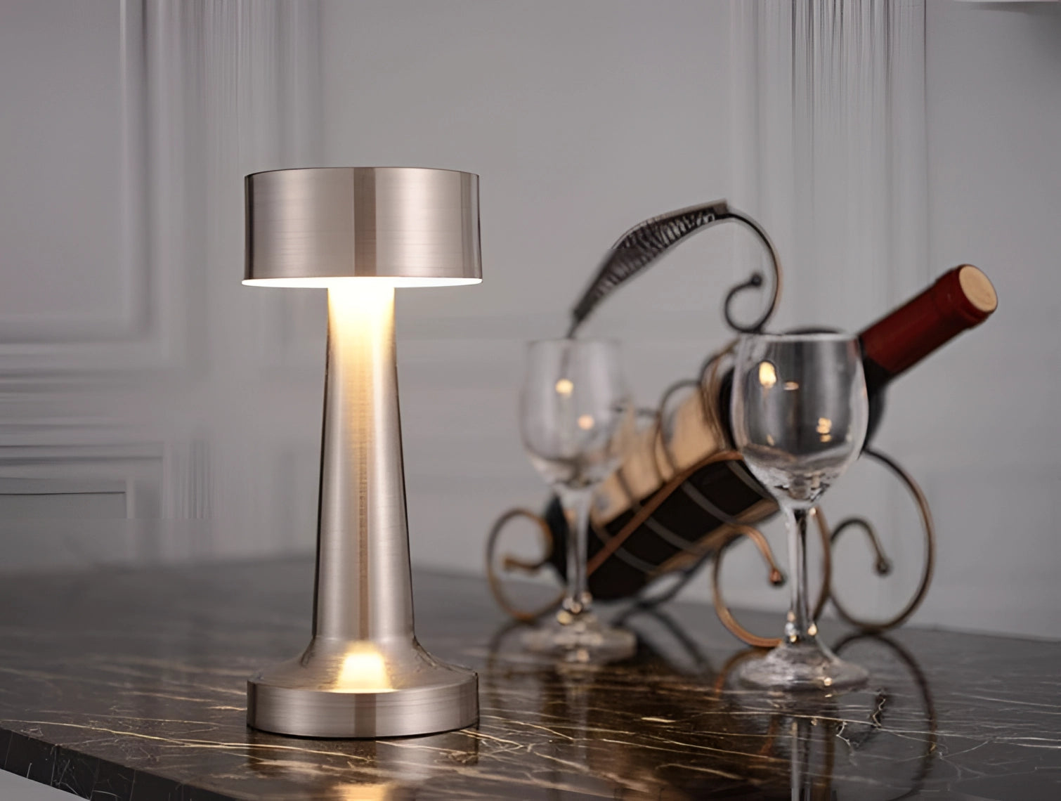 Luxurious gold cordless LED table lamp with a sleek design, featuring a cylindrical glass shade, a wooden base, and a rechargeable battery, ideal for adding a touch of elegance to any table setting.