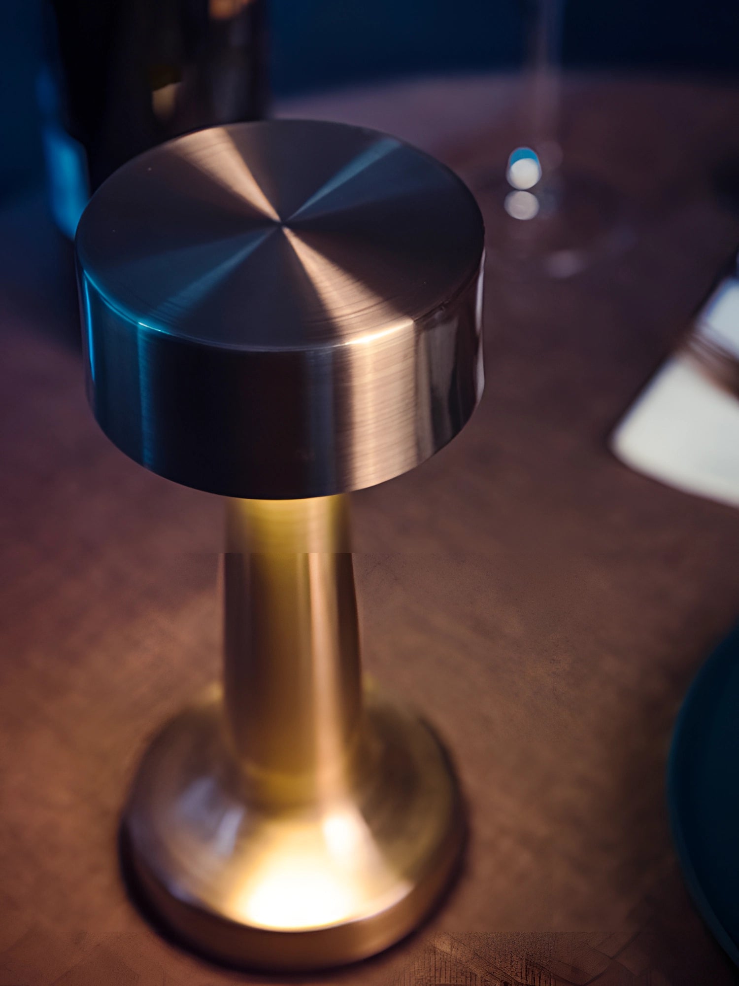 Luxurious gold cordless LED table lamp made from premium metal materials with a sleek, modern design featuring a circular base, portable and rechargeable for convenience.