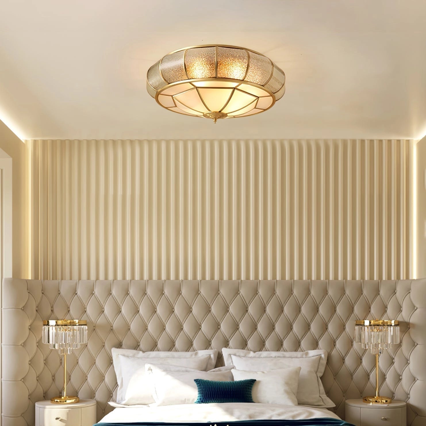 Elegant luxury gold flush mount ceiling light with textured glass and brass accents, installed in a stylish room featuring modern furniture, including a couch and table, creating a comfortable and well-decorated atmosphere with soft lighting and wood elements.
