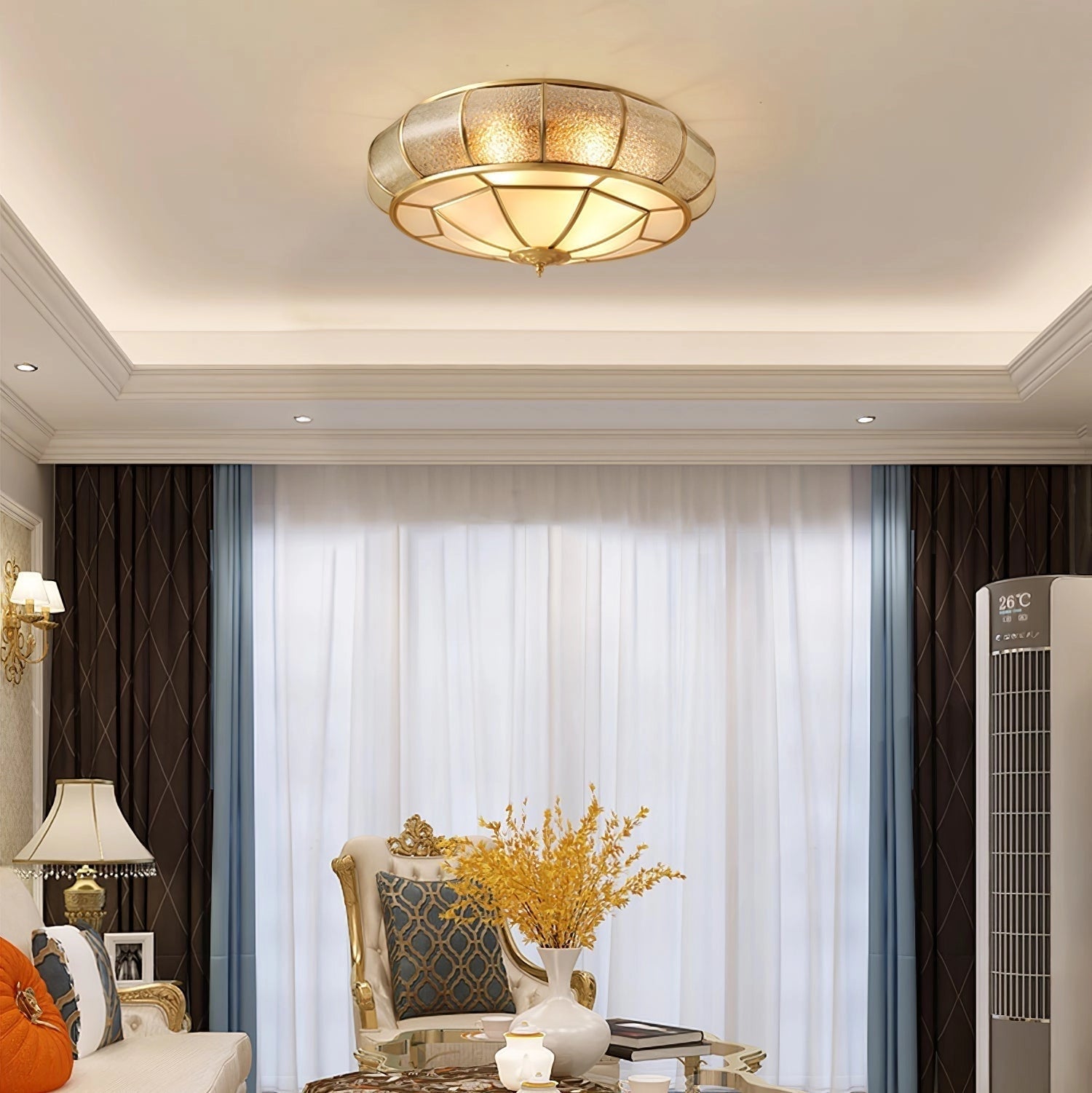 Luxury gold flush mount ceiling light with textured glass and brass accents illuminating a stylish interior space.