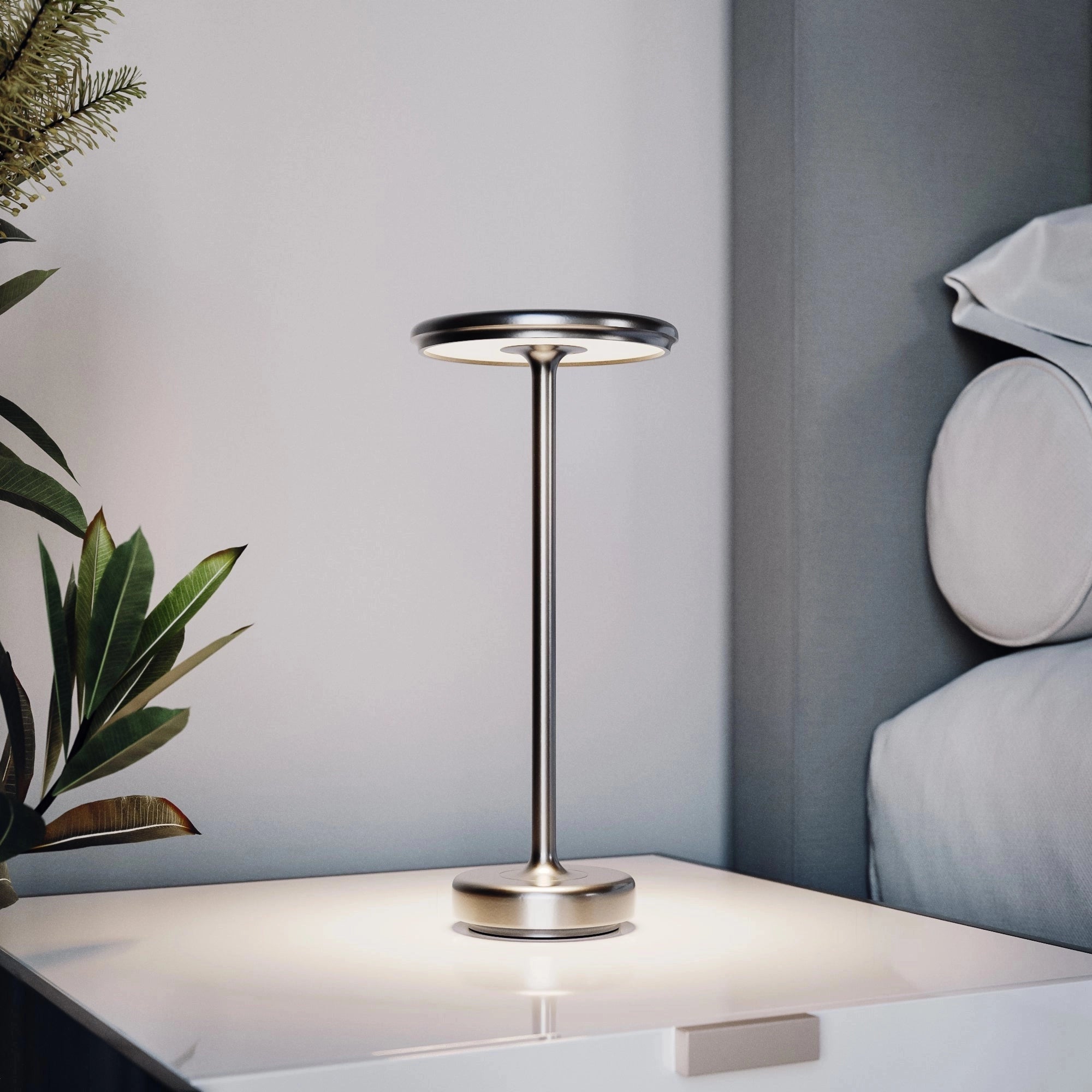 Luxurious gold LED floor lamp with a modern minimalist design, featuring a rectangular shape and wooden elements, illuminating a comfortable space next to a lush plant.