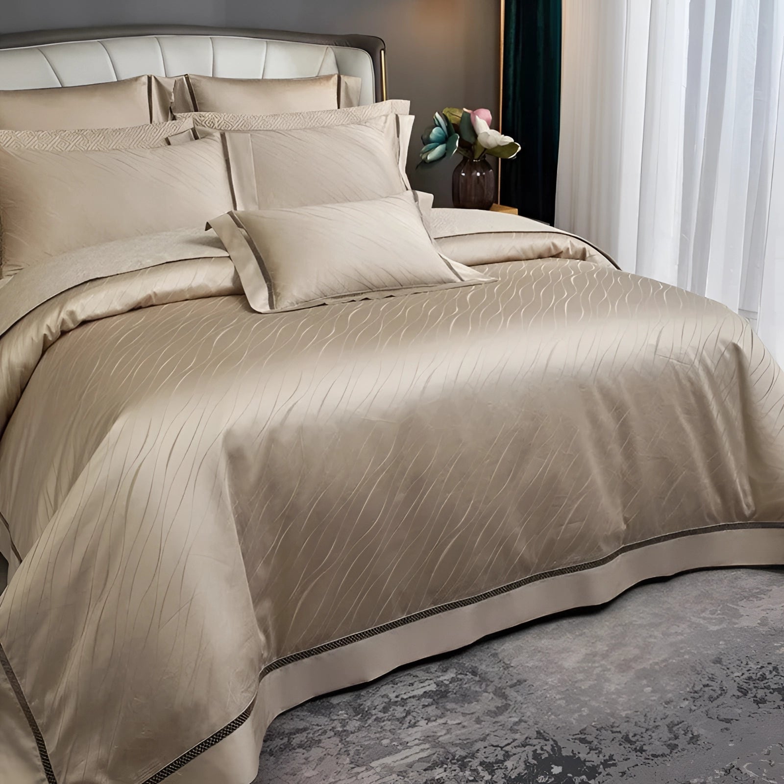 Luxury gold satin bedding set on a modern metallic duvet cover adorning a bed with a wooden frame, complemented by pillows and a nearby lamp on a grey-shaded floor.