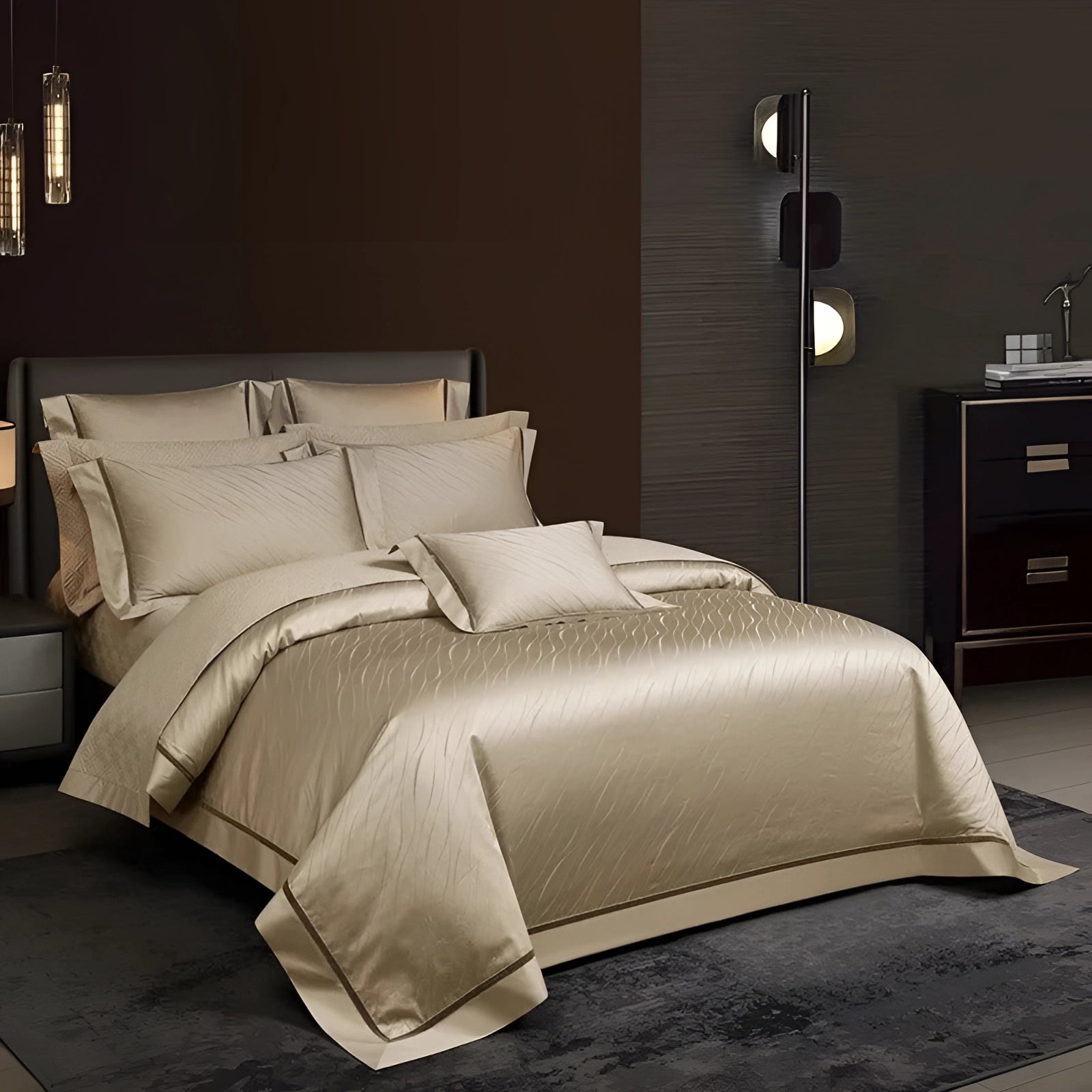 Luxurious gold satin bedding set with a modern metallic duvet cover displayed on a bed frame in an elegantly designed bedroom. The room features a mix of grey and wood elements, complemented by a bedside lamp for ambient lighting and plush pillows for added comfort.