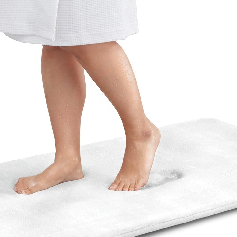 Luxury white memory foam bath mat in an extra-large size (60x90cm) placed on a flooring surface, showcasing its plush texture and non-slip, quick-dry features, ideal for barefoot comfort.