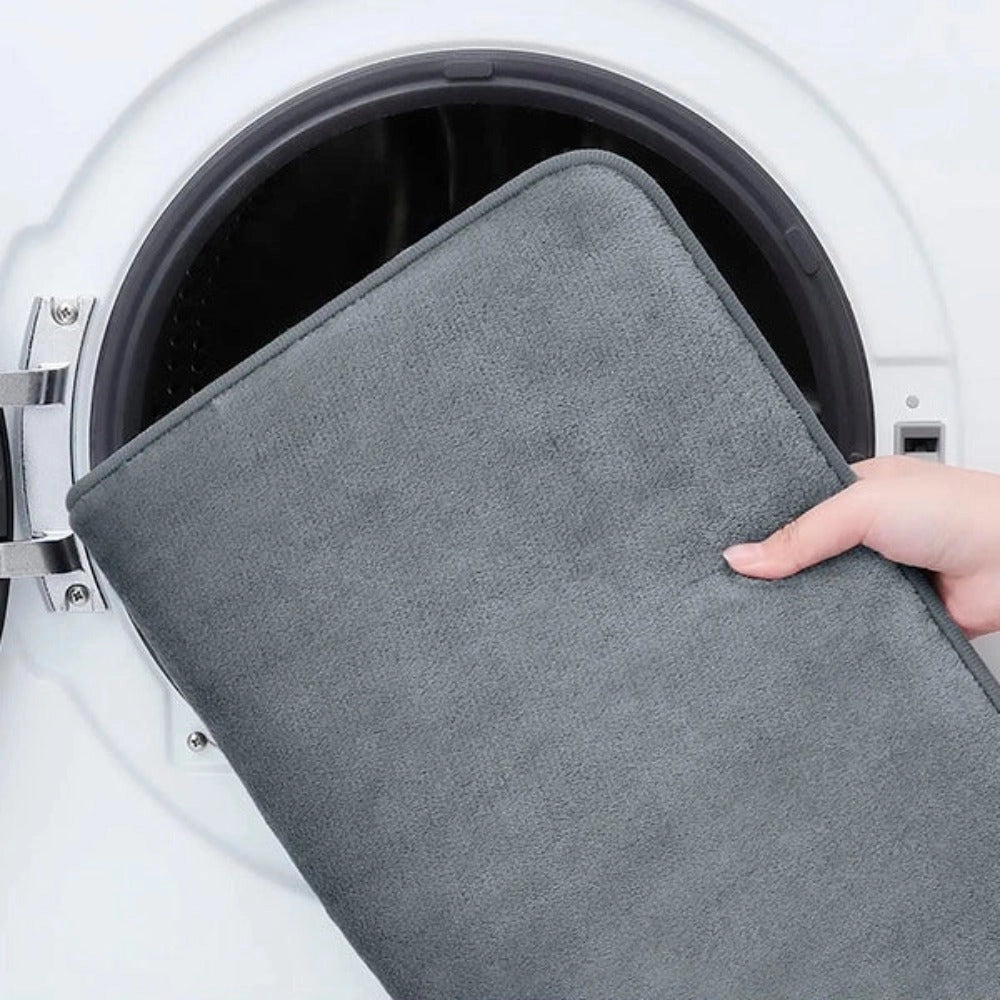 Luxury grey memory foam bath mat with a plush texture, featuring a non-slip backing for safety and quick-dry material for convenience, shown in a clean and modern bathroom setting.