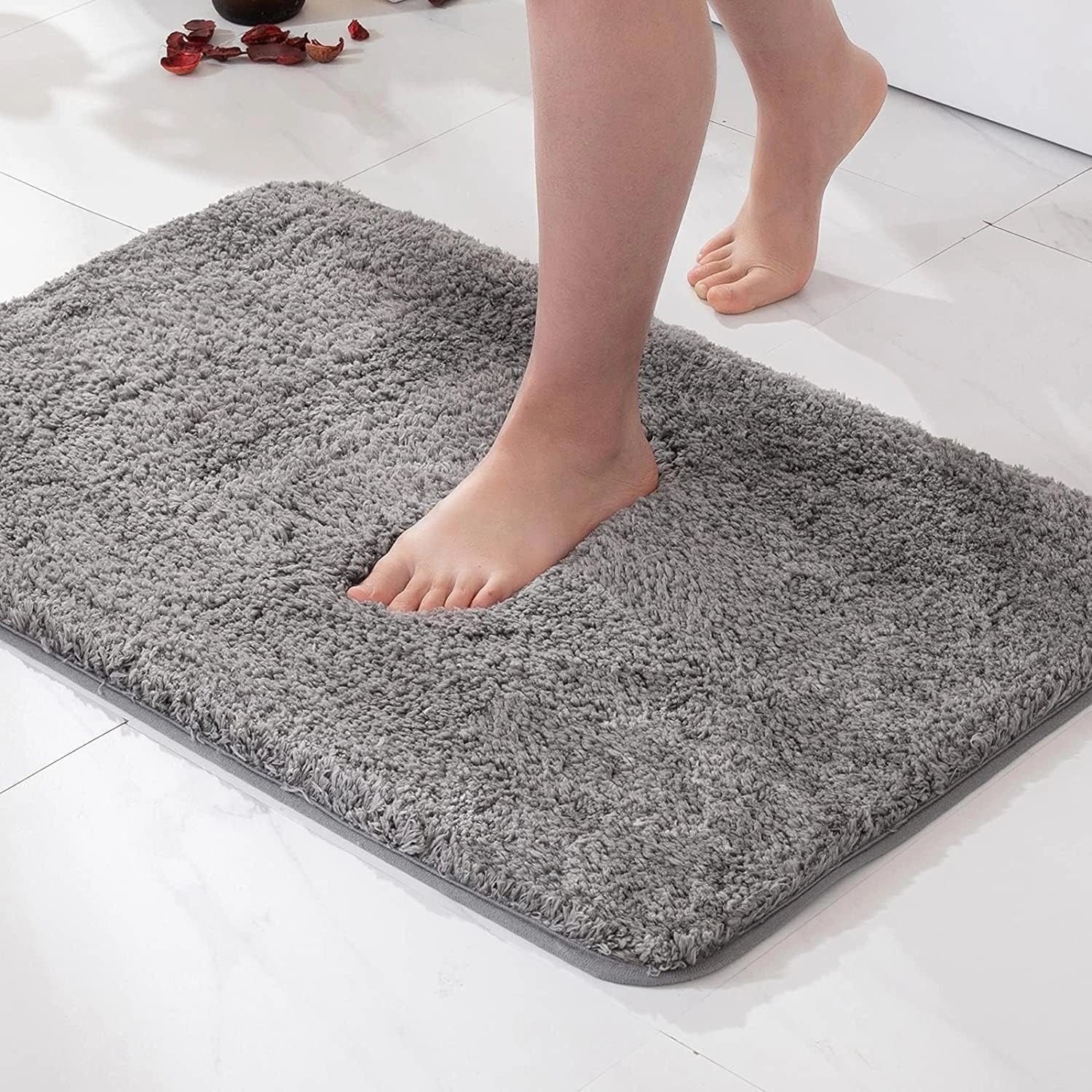 Luxury navy blue plush non-slip quick-dry bath rug in a large size measuring 60x90cm, placed on a wooden floor, featuring a grey color.