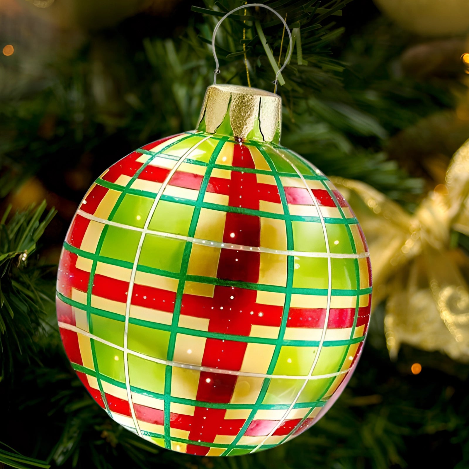 A luxury red plaid tartan glass Christmas ornament hanging on a green Christmas tree, adding a unique decorative touch with its festive red and green colors.