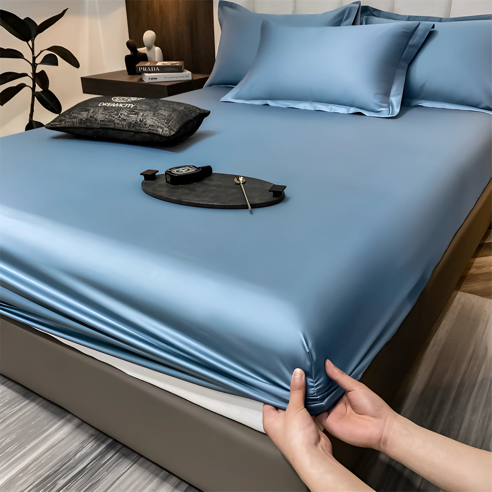 Luxury blue silk satin bedsheet set on a bed with deep pockets, displayed in a rectangular shape, providing a wrinkle-free and comfortable appearance, with a modern and elegant design.