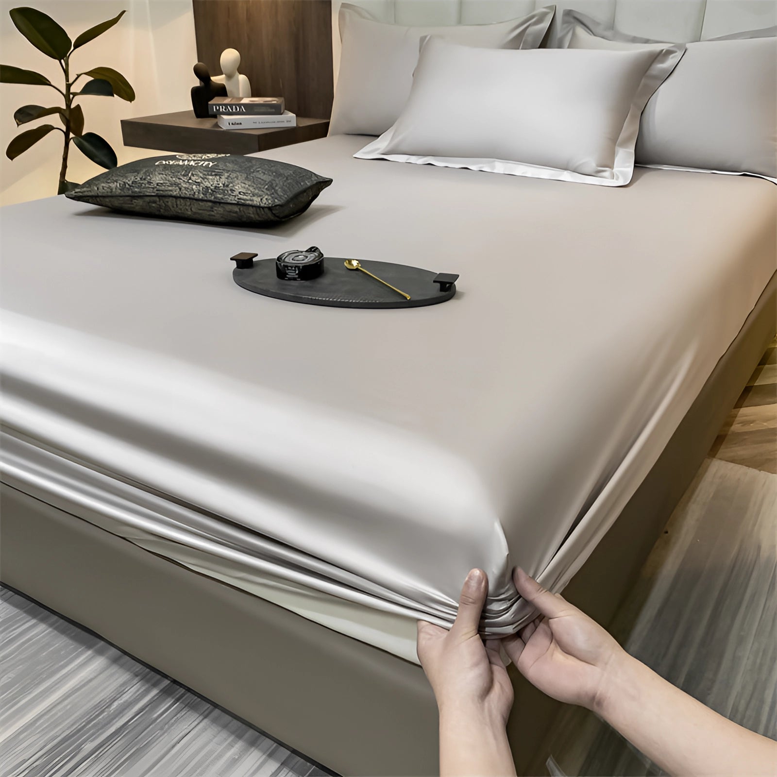 Luxurious gray silk satin bedsheet set with deep pockets, displayed on a bed with a wooden frame, showcasing a smooth and wrinkle-free finish.