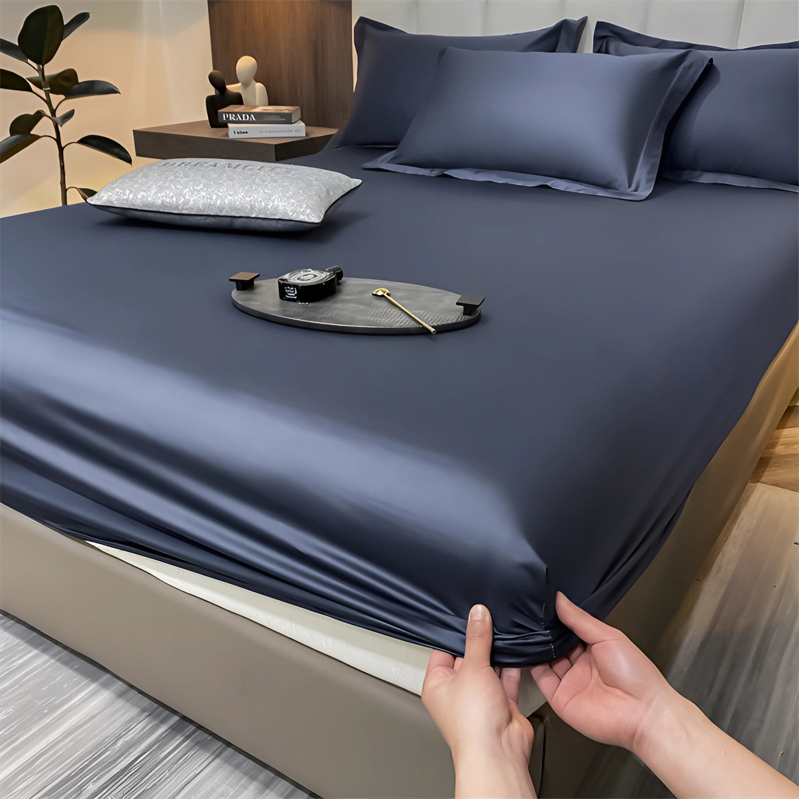 Luxury red silk satin bedsheet set with a smooth, wrinkle-free texture and deep pockets, displayed in a dark blue variant, measuring 200x220x30cm, laid out on a bed.