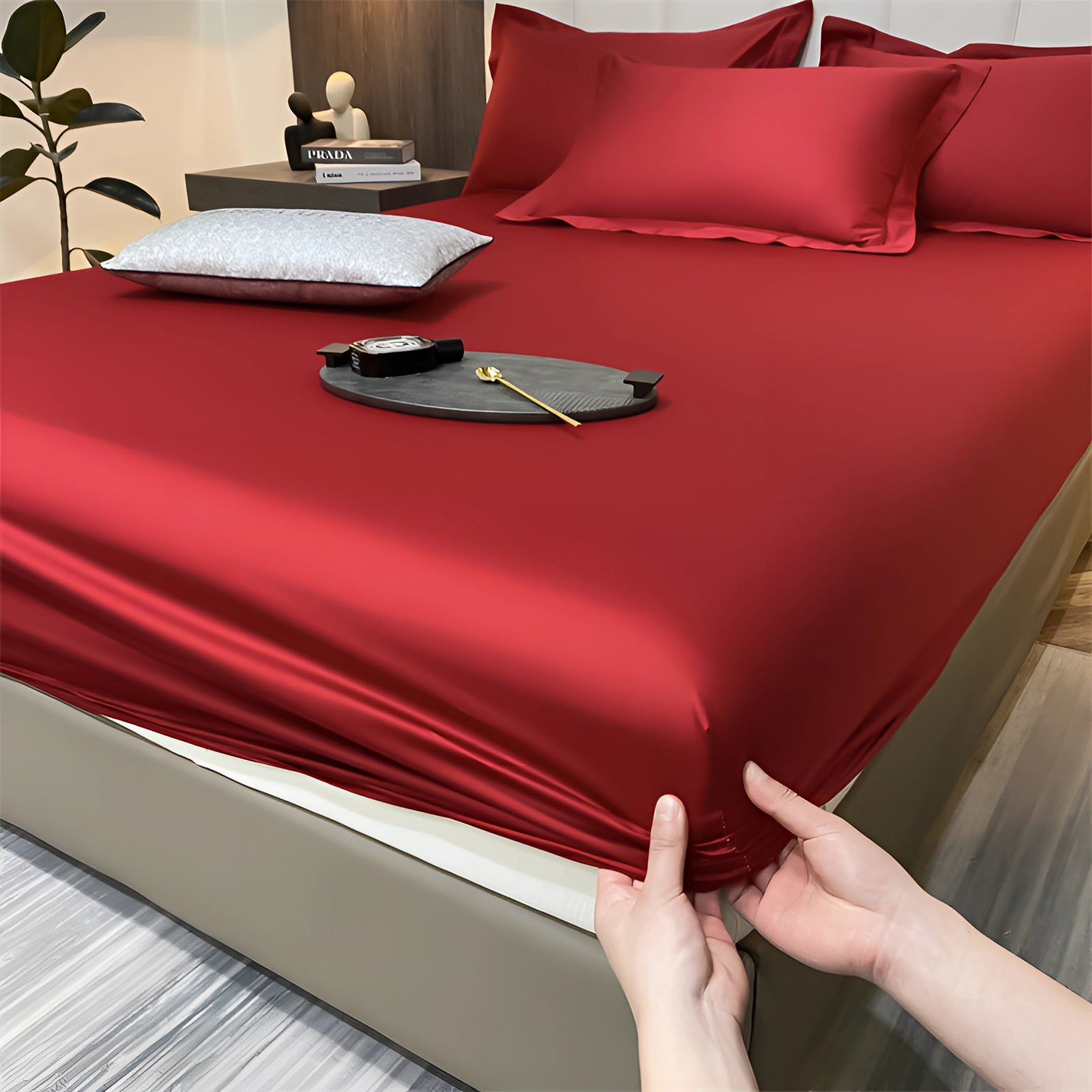Luxury red silk satin bedsheet set with a wrinkle-free finish on a bed, showcasing deep pockets, dimensions 200x220x30cm, elegantly styled in a bedroom setting.