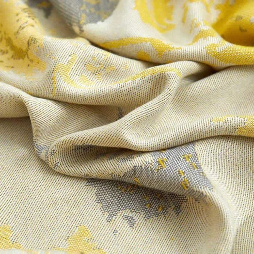 Luxurious silk floral throw blanket featuring an elegant and intricate pattern, predominantly in shades of beige and peach, ideal for sophisticated home decor.