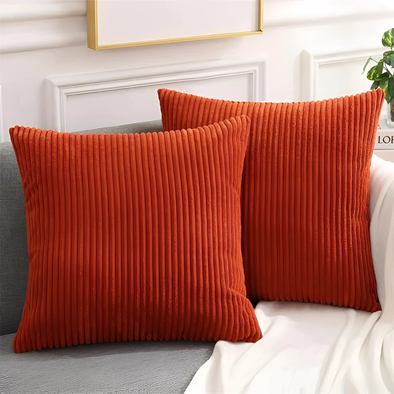 Luxury rust red soft corduroy cushion cover in a 50x50cm rectangular shape, made from high-quality upholstery fabric, displayed on a wooden floor.