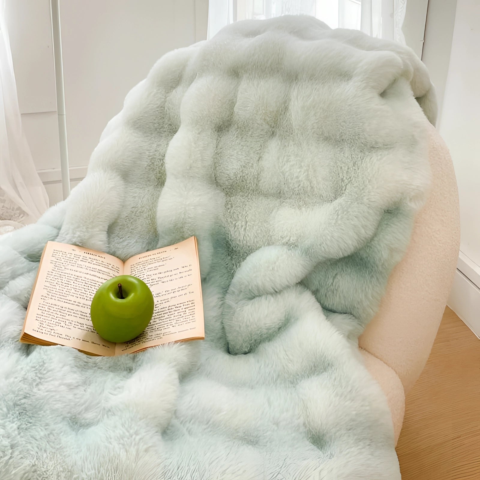 Luxury white faux fur accent chair with plush and cozy texture, suitable for creating a comfortable reading nook. Features light green elements and appears to be upholstered in a wool-like material, adding a touch of elegance and warmth.