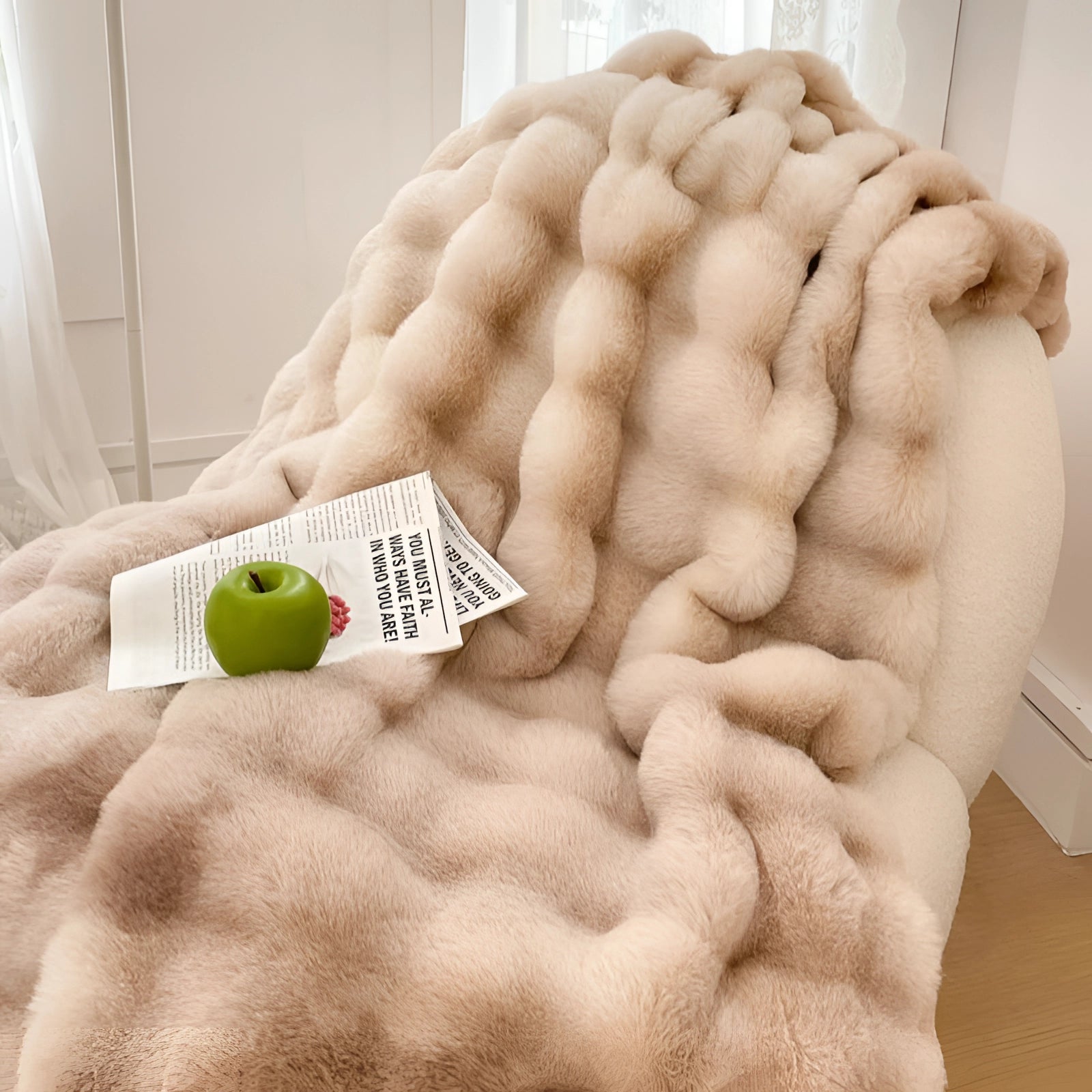 Luxury white faux fur accent chair placed in a cozy reading nook, showcasing its plush and inviting texture.