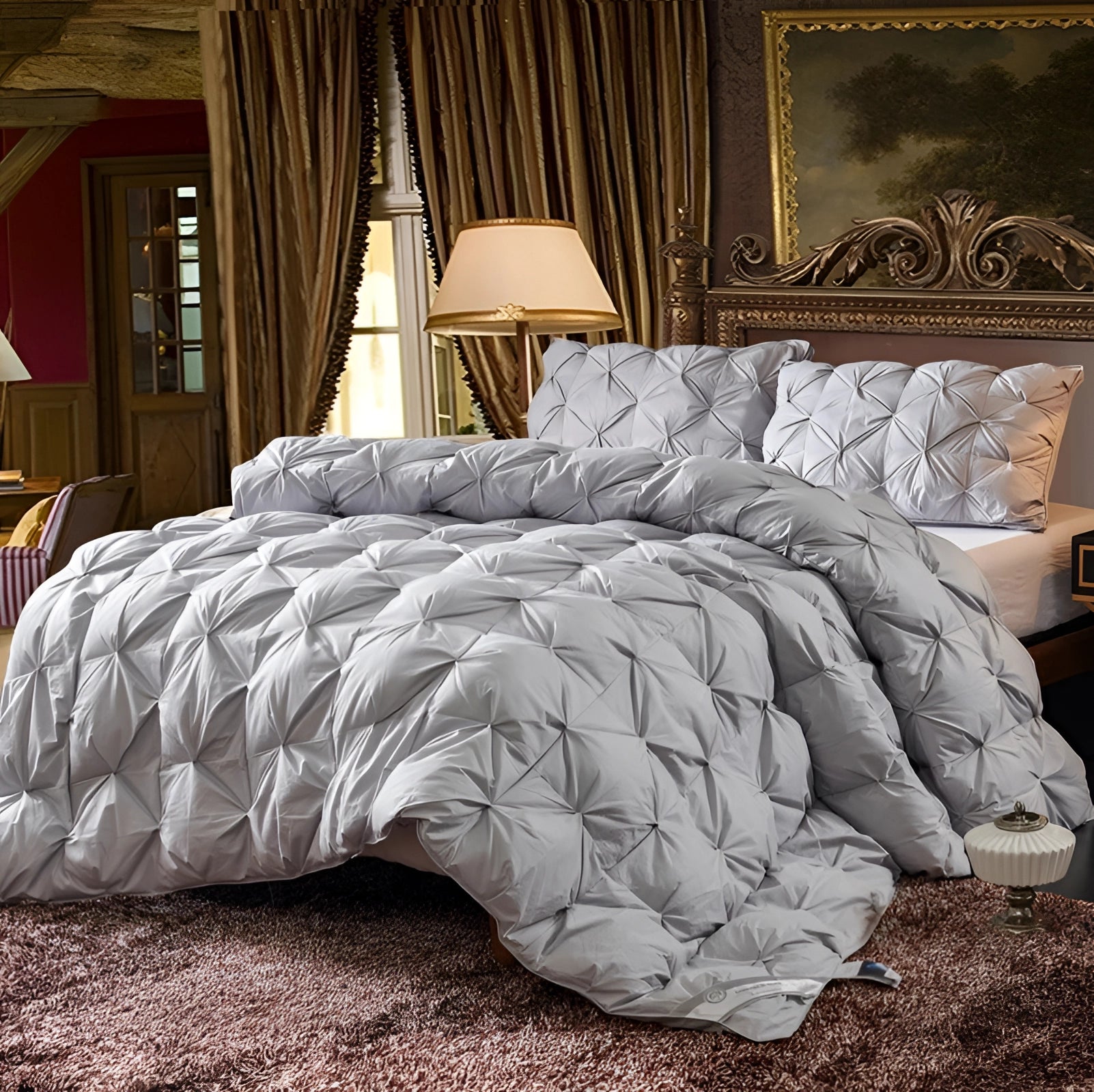 Luxury white pinch pleat comforter set on a bed with an elegant and textured design, surrounded by a wooden bed frame, grey flooring, a lamp, and a curtain, creating a cozy and comfortable bedroom ambiance.
